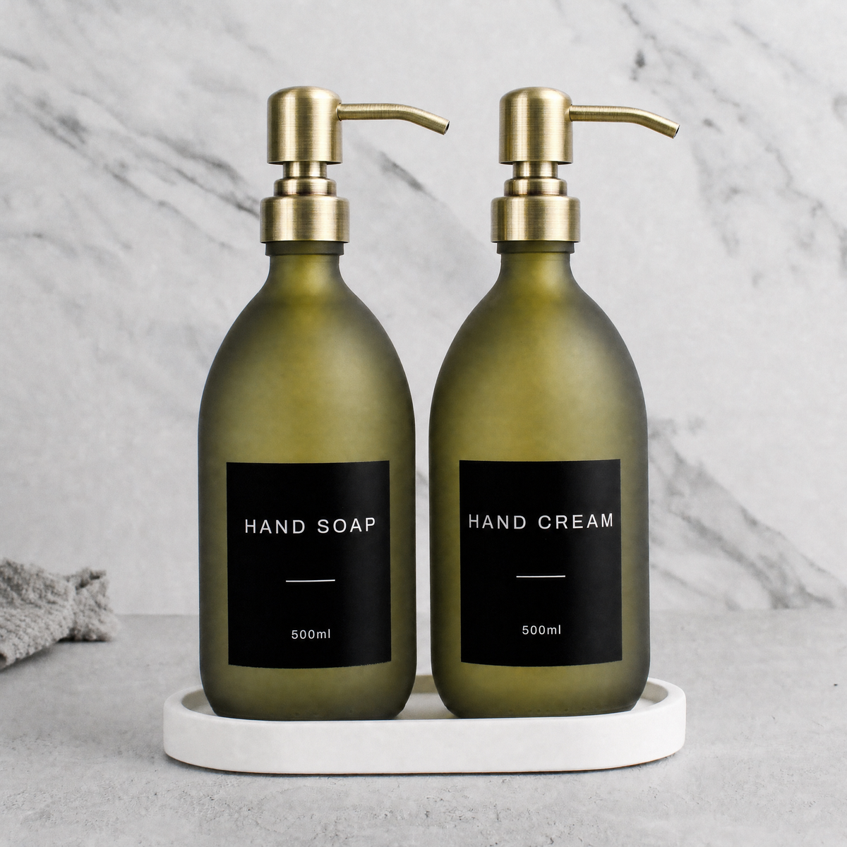 White Tray & Frosted Green Glass Hand Soap & Hand Cream Set on a white stone tray, gold pumps