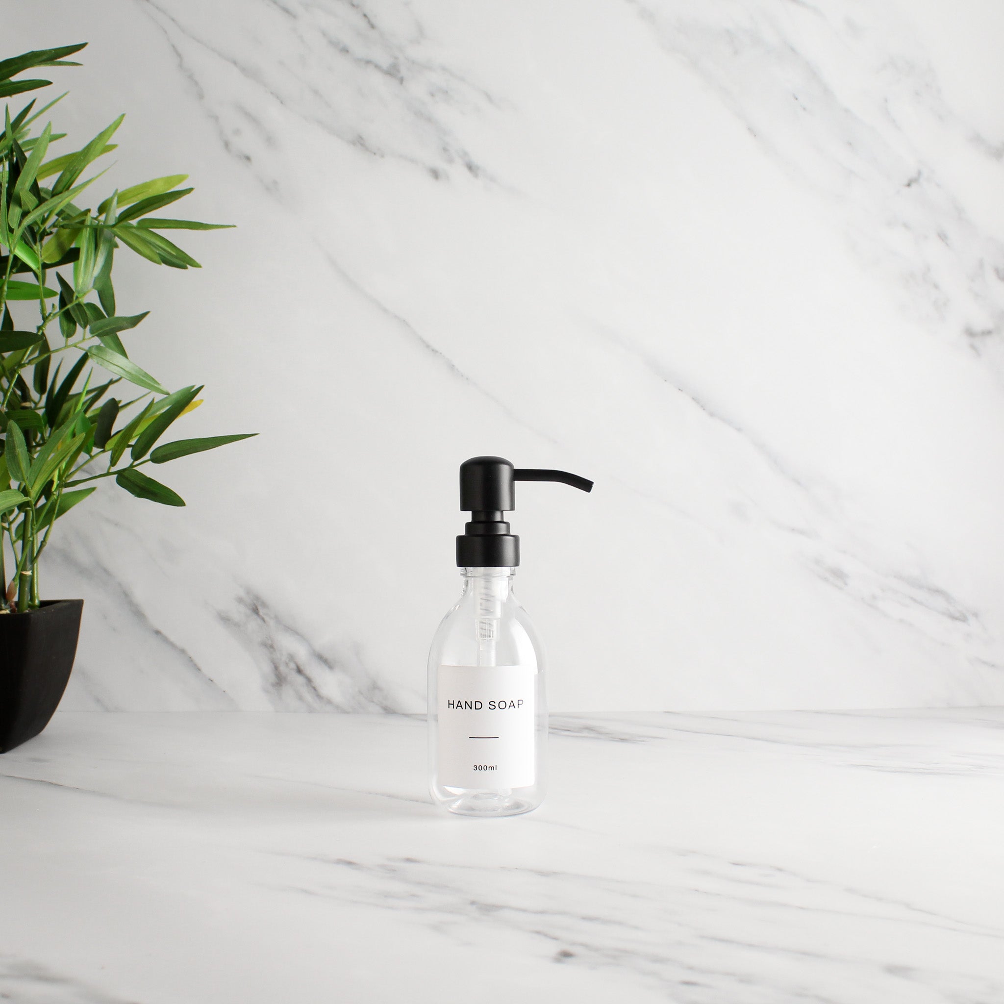 Labelled Clear Plastic Dispenser Bottle With Matte Black Pump - Namie Home