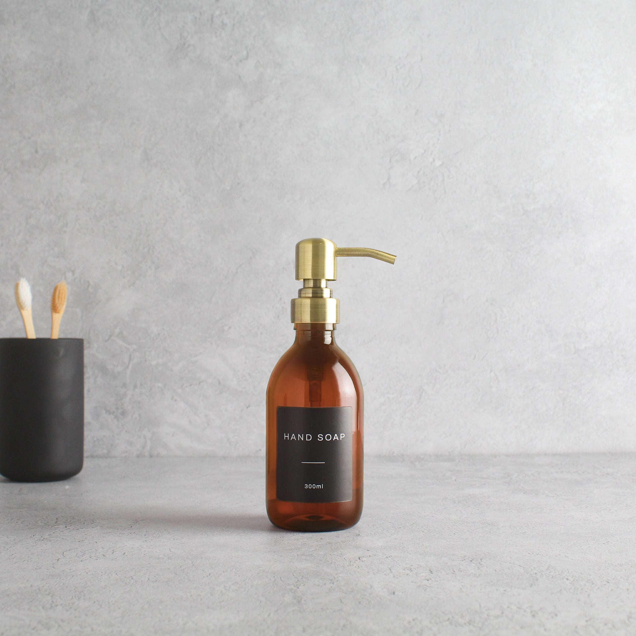 Labelled Amber Plastic Dispenser Bottle With Gold Pump - Namie Home