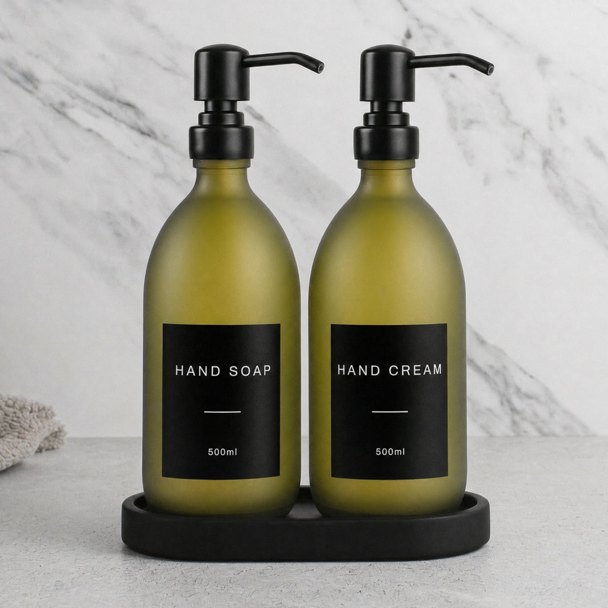 Black Tray & Frosted Green Glass Hand Soap & Hand Cream Set on a black stone tray, matte black pumps