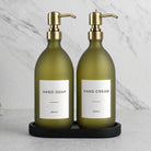 Black Tray & Frosted Green Glass Hand Soap & Hand Cream Set on a black stone tray, gold pumps