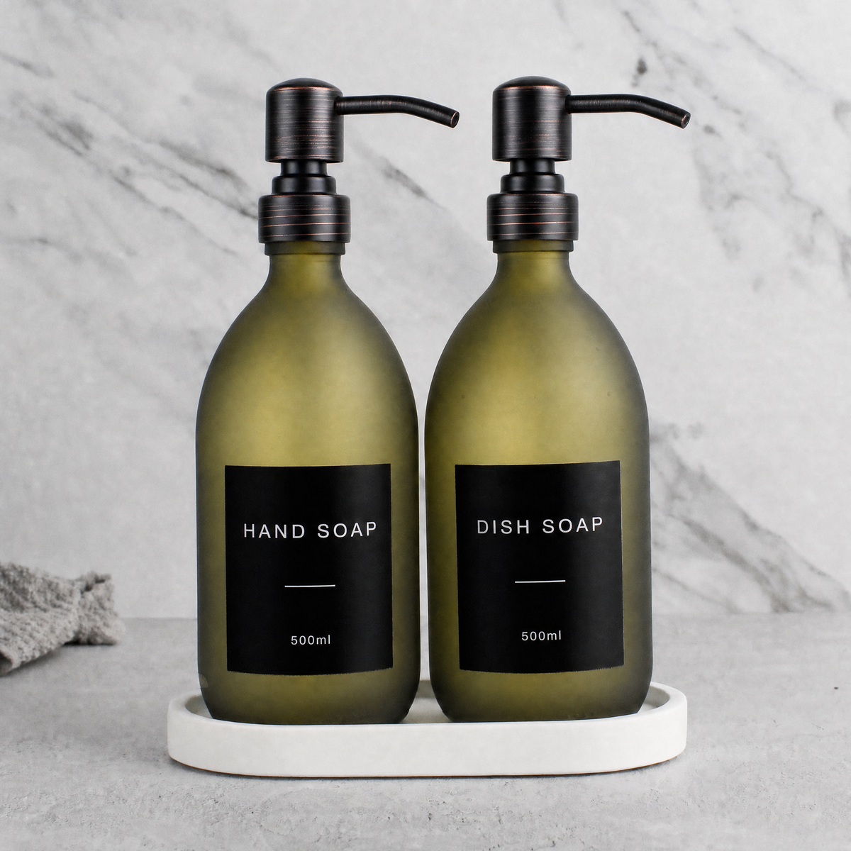 White Tray & Frosted Green Glass Hand Soap & Dish Soap Set on a white stone tray, black and copper pumps