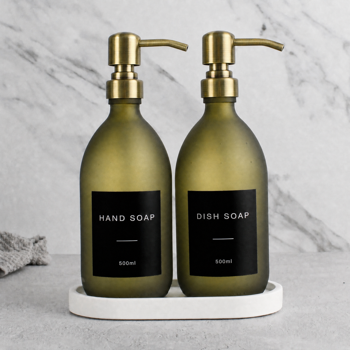 White Tray & Frosted Green Glass Hand Soap & Dish Soap Set on a white stone tray, gold pumps
