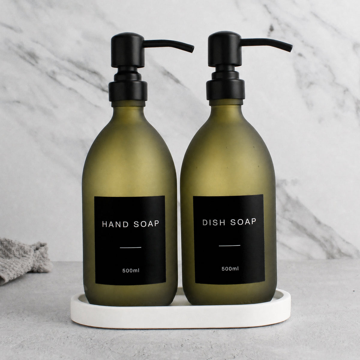 White Tray & Frosted Green Glass Hand Soap & Dish Soap Set on a white stone tray, matte black pumps