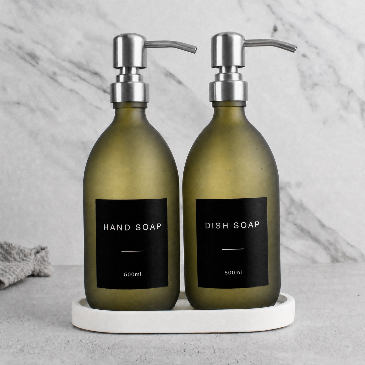 White Tray & Frosted Green Glass Hand Soap & Dish Soap Set on a white stone tray, silver pumps