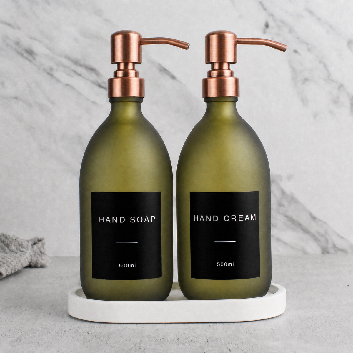 White Tray & Frosted Green Glass Hand Soap & Hand Cream Set on a white stone tray, rose gold pumps