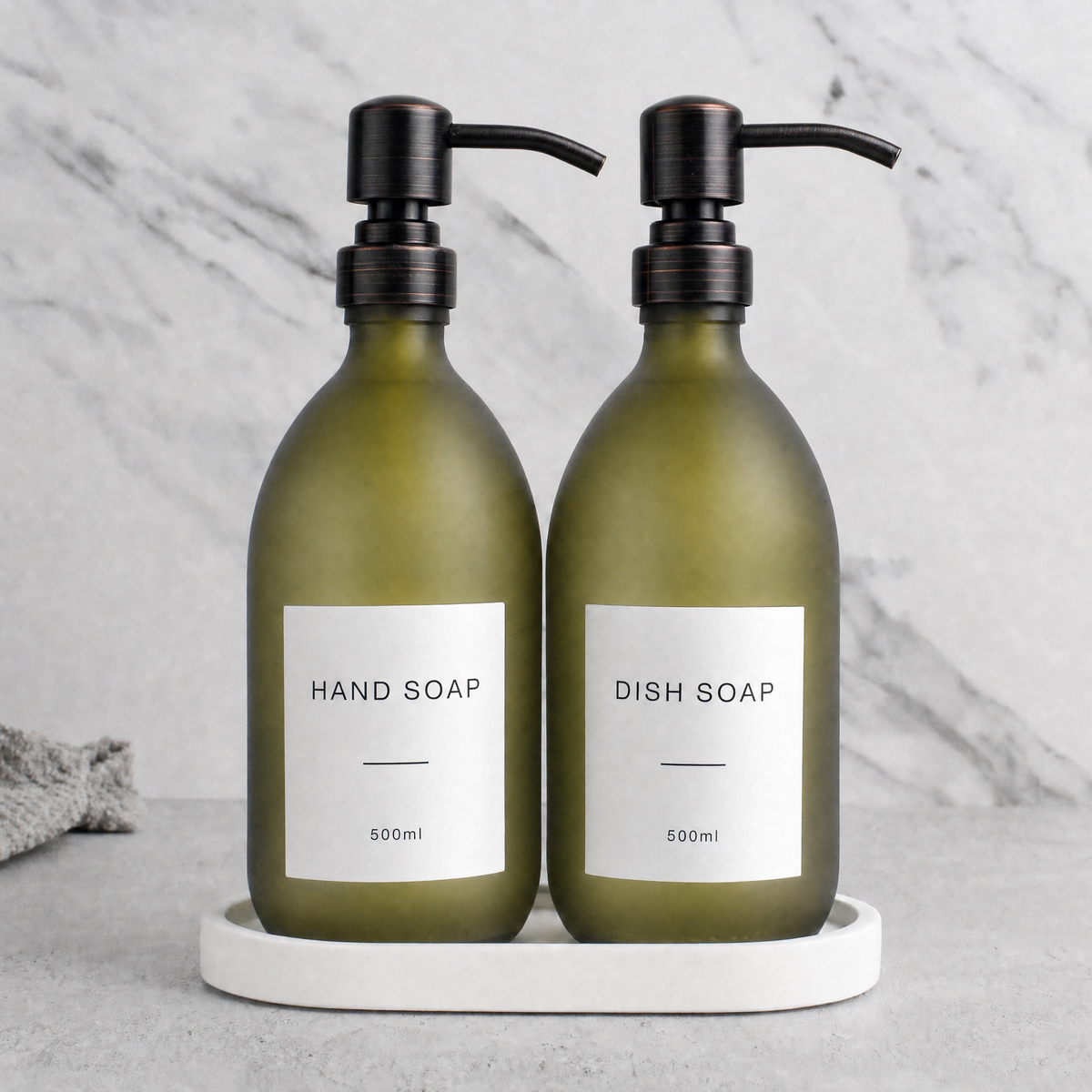 White Tray & Frosted Green Glass Hand Soap & Dish Soap Set on a white stone tray, black and copper pumps