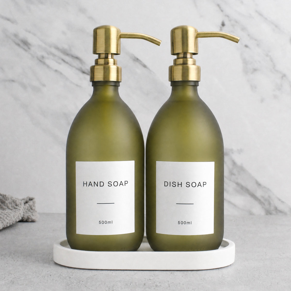 White Tray & Frosted Green Glass Hand Soap & Dish Soap Set on a white stone tray, gold pumps