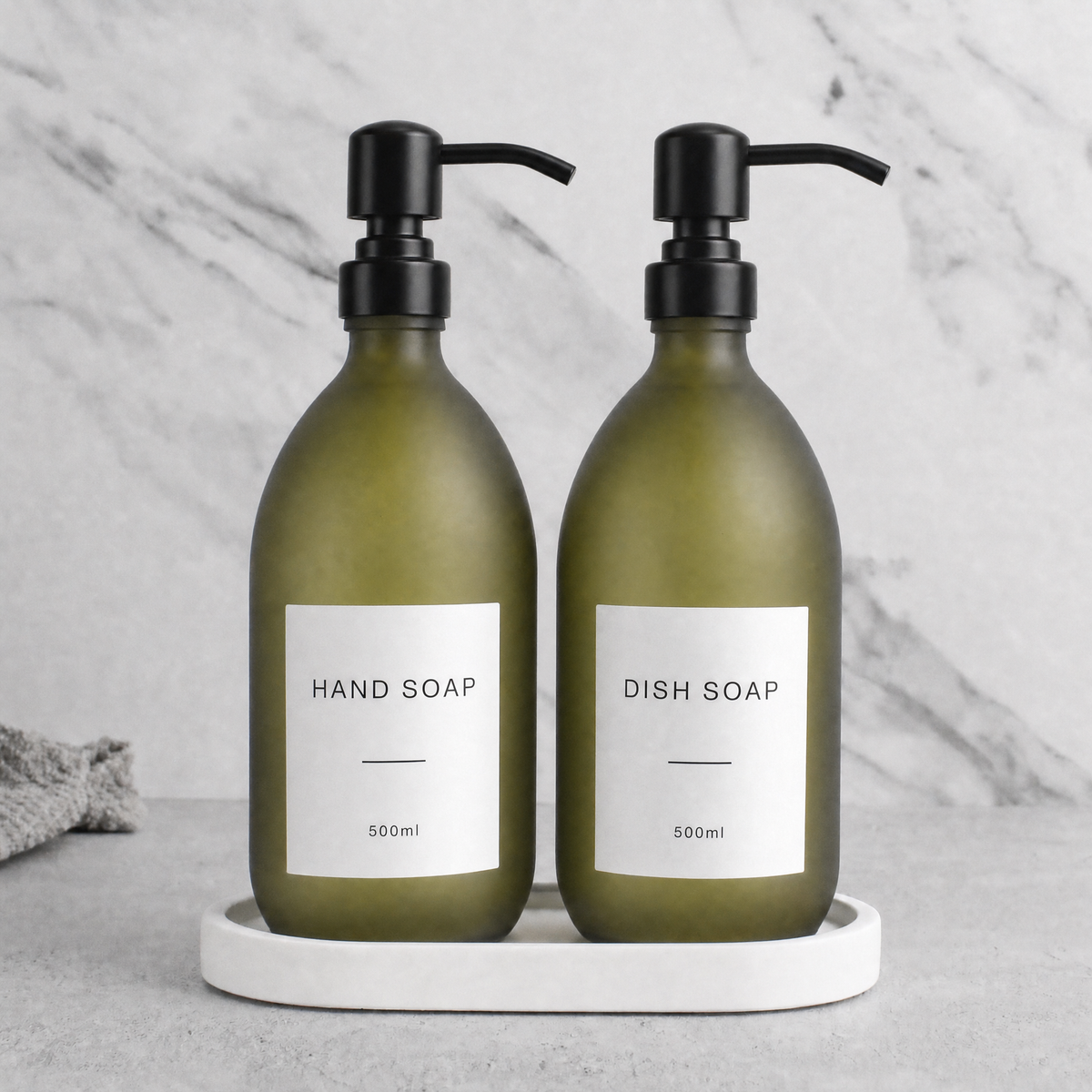 White Tray & Frosted Green Glass Hand Soap & Dish Soap Set on a white stone tray, matte black pumps