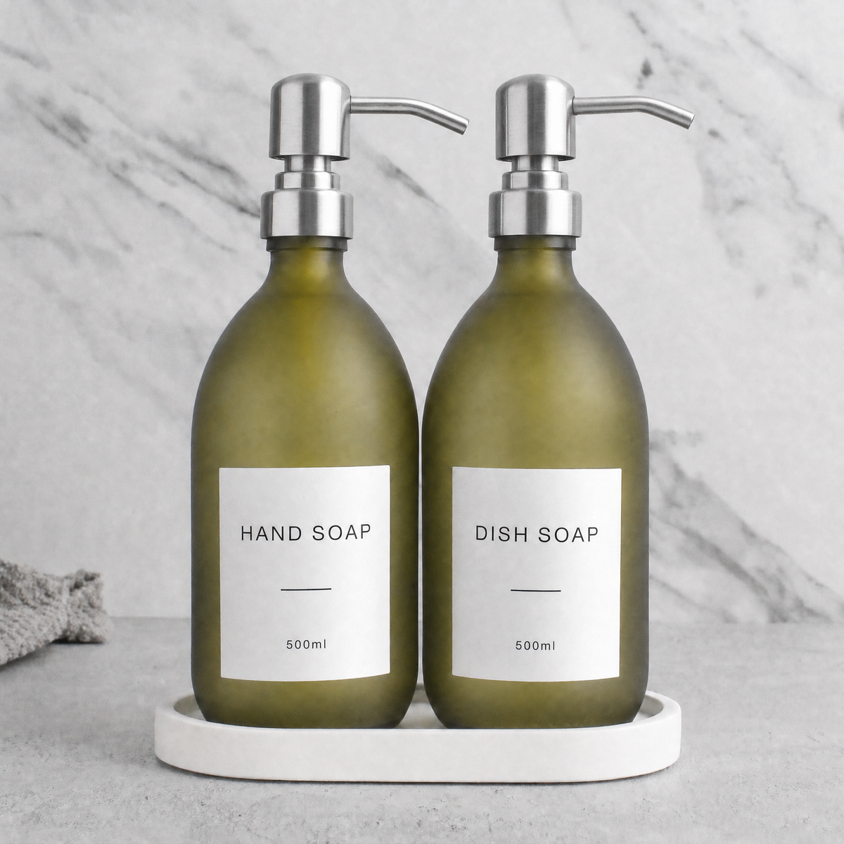 White Tray & Frosted Green Glass Hand Soap & Dish Soap Set on a white stone tray, silver pumps