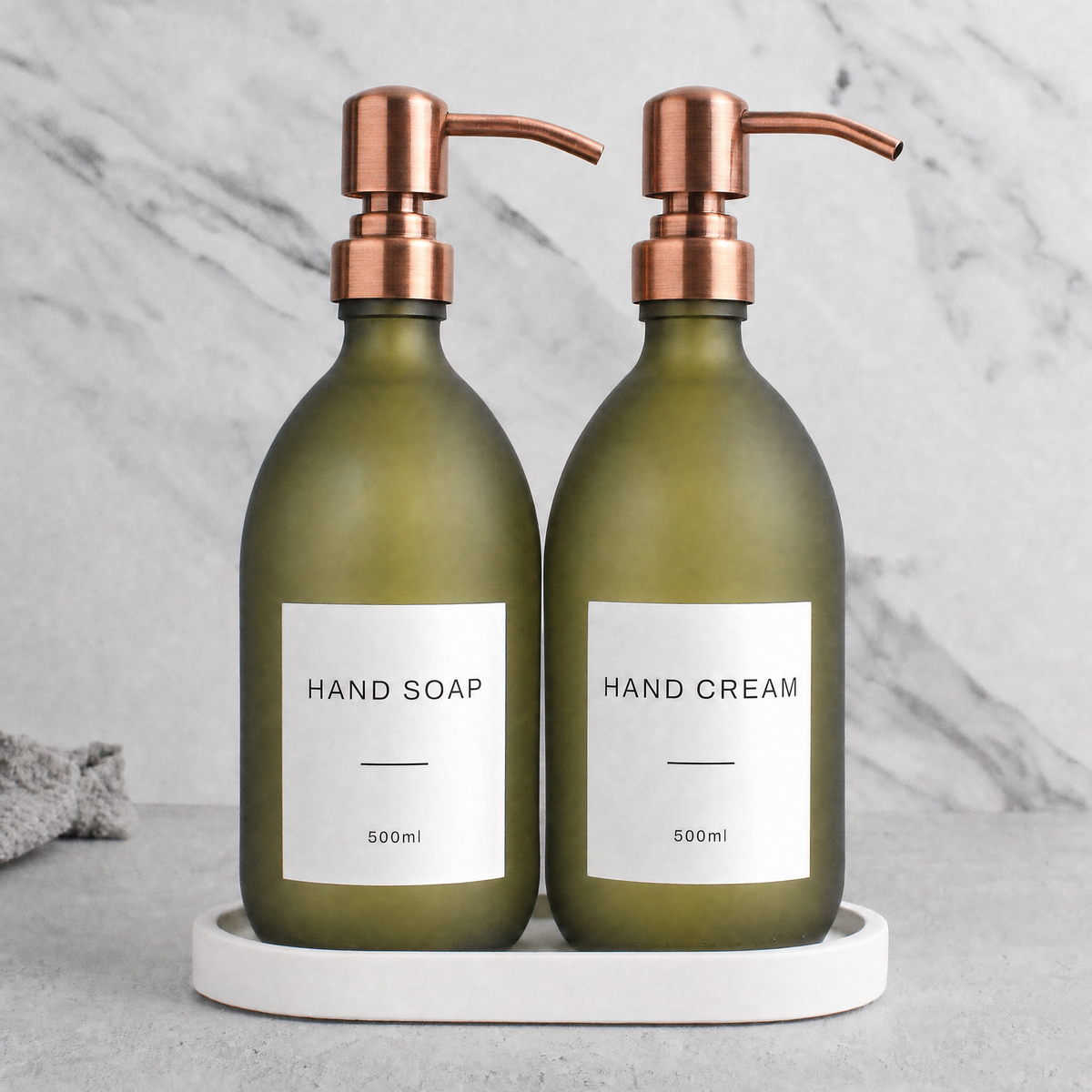White Tray & Frosted Green Glass Hand Soap & Hand Cream Set on a white stone tray, rose gold pumps