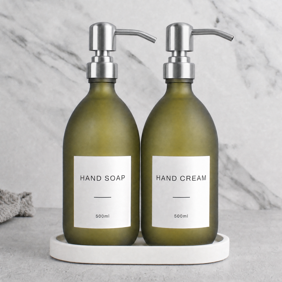 White Tray & Frosted Green Glass Hand Soap & Hand Cream Set on a white stone tray, silver pumps