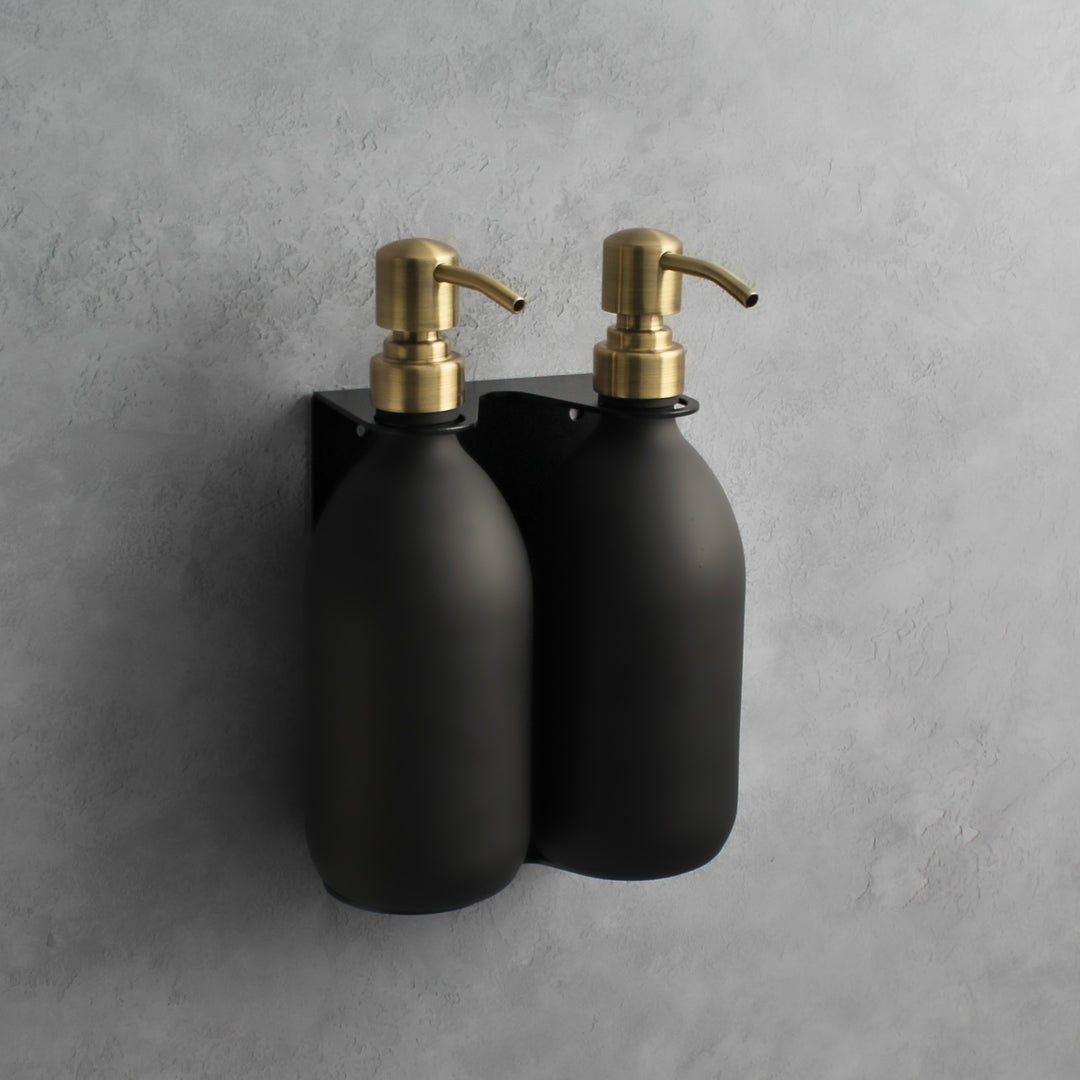 Matte black glass soap dispenser bottle set on metal wall mounted bracket for hand soap and hand cream for hotels, home, spas, cafe, restaurant, b&b