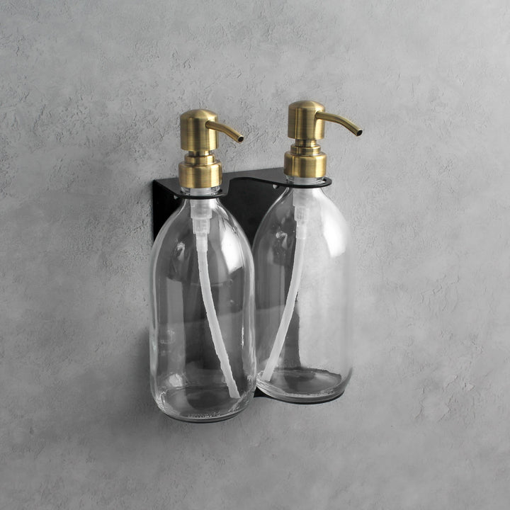 Clear glass soap dispenser bottle set on metal wall mounted bracket for hand soap and hand cream for hotels, home, spas, cafe, restaurant, b&b