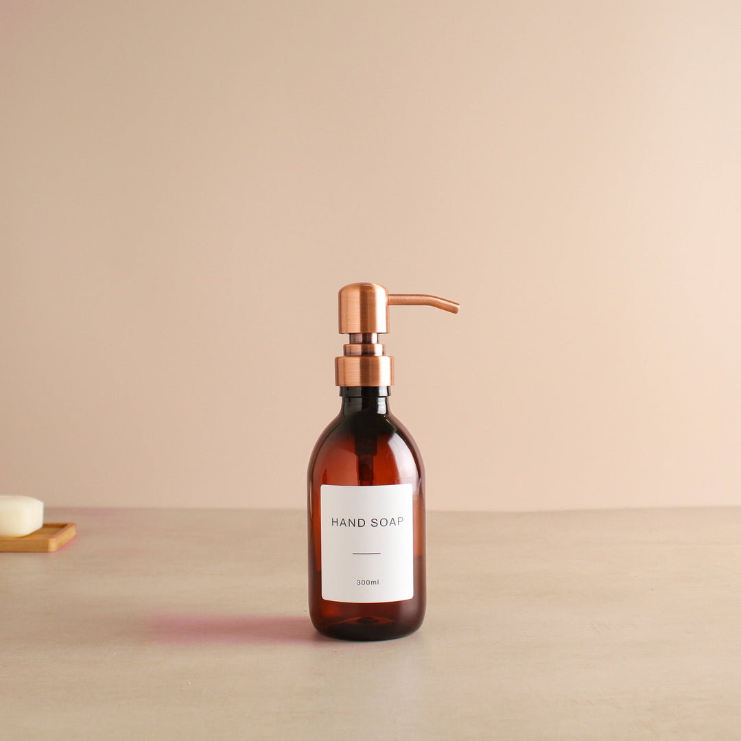 Labelled Amber Plastic Dispenser Bottle With Rose Gold Pump - Namie Home